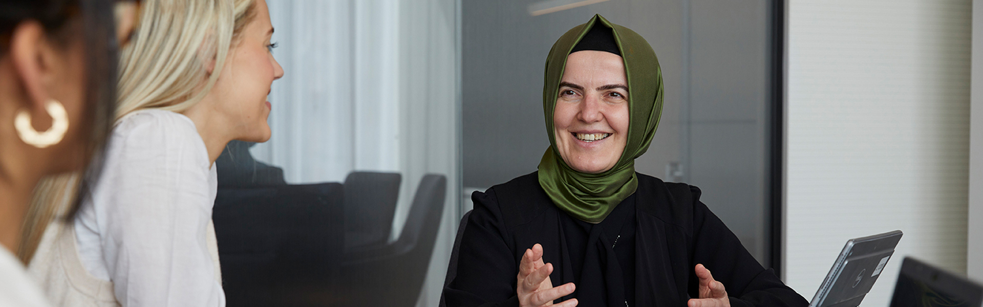 SMBC Employee on laptop in conference room