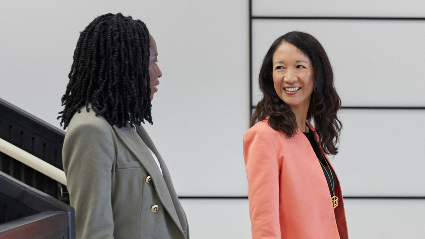 Two SMBC employees walking and talking